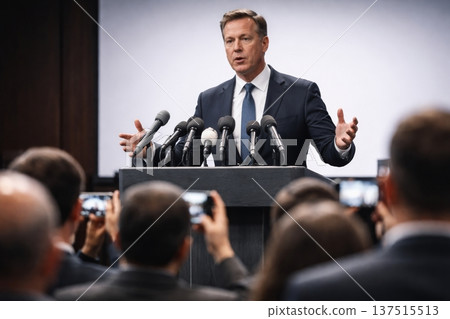 Politician speaking at podium. Public official addresses journalists during press conference, speaking at podium with microphones, symbolizing leadership, politics, and media communication. Politician speaking at podium. Public official addresses journalists during press conference, speaking at podium with microphones, symbolizing leadership, politics, and media communication. 137515513