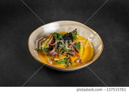 Pumpkin salad with dried duck, cherry tomatoes and pumpkin seeds. Close-up, selective focus Pumpkin salad with dried duck, cherry tomatoes and pumpkin seeds. Close-up, selective focus 137515761