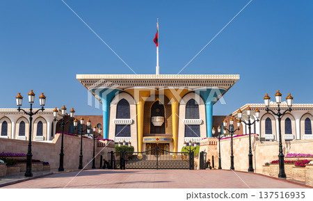 Architectural detail of the iconic Al Alam Palace with its golden pillars and blue arches against a clear sky in Muscat, Oman. Architectural detail of the iconic Al Alam Palace with its golden pillars and blue arches against a clear sky in Muscat, Oman. 137516935