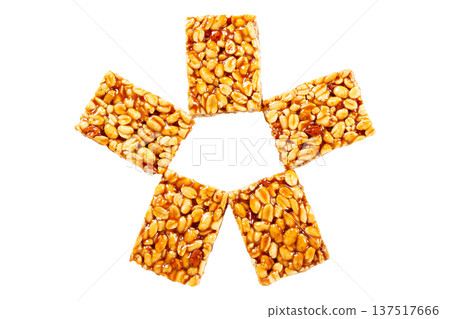 Five pieces of peanut brittle Brazilian peanut candy, made with caramelized peanuts, arranged in a circular shape and isolated on a white background. A traditional Brazilian sweet Five pieces of peanut brittle Brazilian peanut candy, made with caramelized peanuts, arranged in a circular shape and isolated on a white background. A traditional Brazilian sweet 137517666