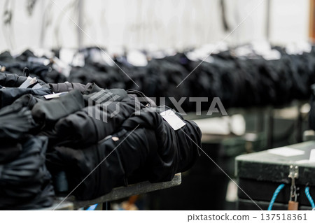 Rows of graduation gowns organized for an upcoming university ceremony in England, reflecting classic academic tradition and celebration. Rows of graduation gowns organized for an upcoming university ceremony in England, reflecting classic academic tradition and celebration. 137518361