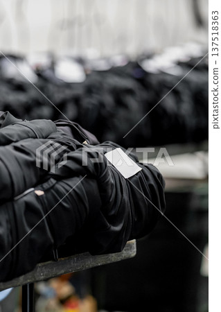 Rows of graduation gowns organized for an upcoming university ceremony in England, reflecting classic academic tradition and celebration. Rows of graduation gowns organized for an upcoming university ceremony in England, reflecting classic academic tradition and celebration. 137518363