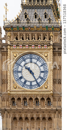Detailed close view of the Big Ben clock face on the Elizabeth Tower highlighting intricate gothic stonework at the Palace of Westminster in London. 137518368