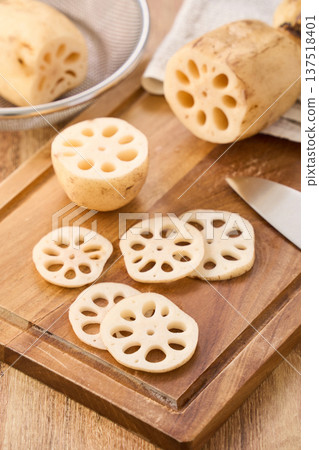 Cut lotus root prepared on a cutting board 137518401