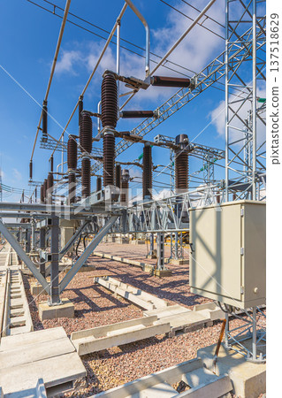 Vertical view of an outdoor electrical distribution substation, without people, at daytime on a background of a clear blue sky 137518629