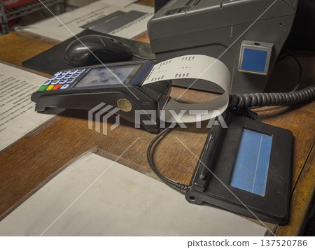 POS Payment Terminal Printing Receipt Closeup POS Payment Terminal Printing Receipt Closeup 137520786