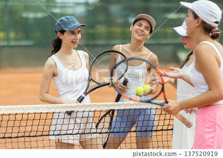 Girls chat on court between tennis games 137520919