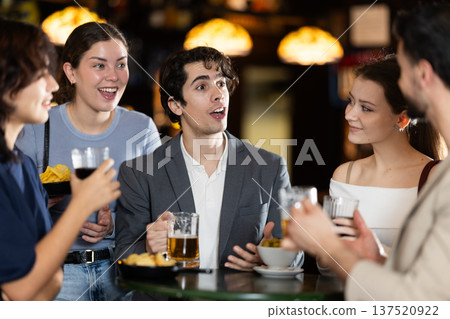 Group of friends happily having time at bar 137520922