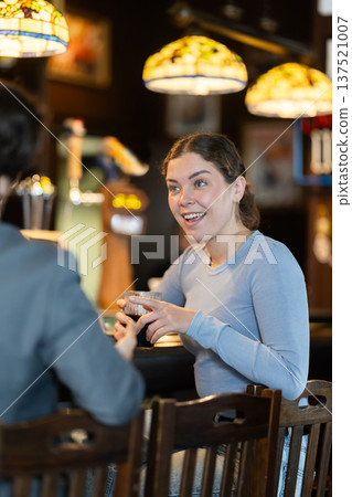 Man flirting with woman, they smile at each other Man flirting with woman, they smile at each other 137521007