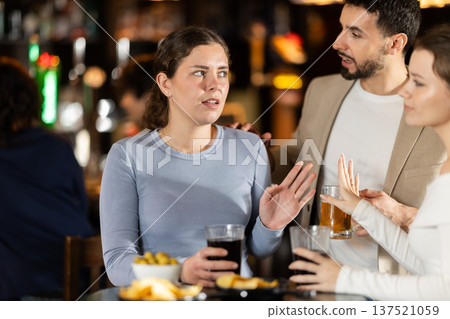Young man flirting with two women getting rejected 137521059