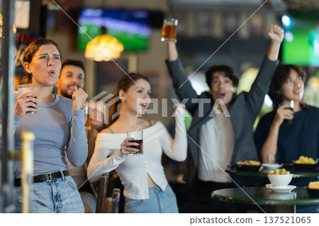 Group of friends celebrating team victory while watching sports match Group of friends celebrating team victory while watching sports match 137521065