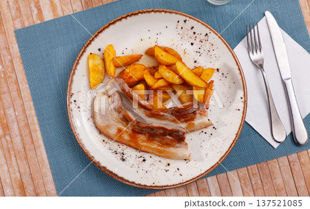 Fried pork belly with potatoes on plate 137521085