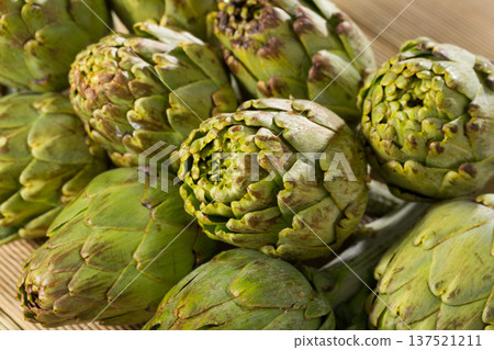 Artichokes on wooden table 137521211