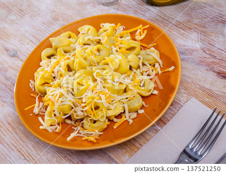 Tortellini garnished with grated cheese and pignoli 137521250