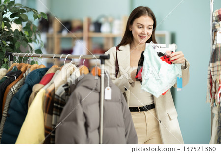 Young woman chooses panties in clothing store 137521360