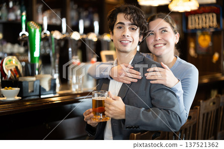 Couple on the background of the bar counter smiling Couple on the background of the bar counter smiling 137521362