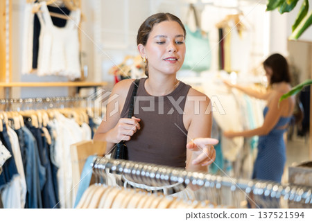 Young woman choosing clothes in a store in summer 137521594