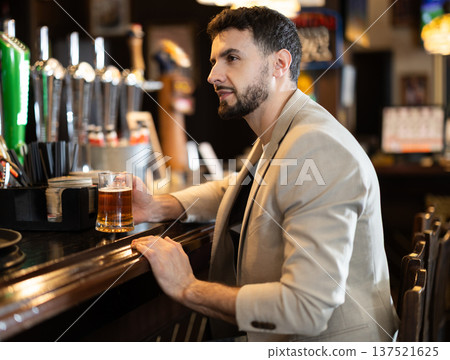 Young man spending time alone at bar 137521625