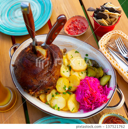 German ham hock with potato on wooden table German ham hock with potato on wooden table 137521762