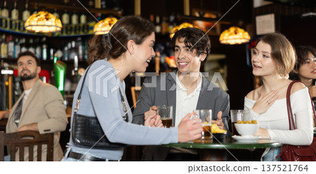 Group of friends at bar talking and drinking beer Group of friends at bar talking and drinking beer 137521764