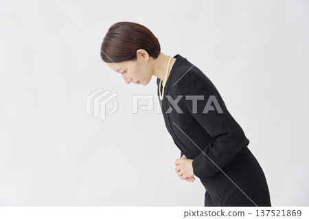 Woman in mourning clothes bowing white background facing left Woman in mourning clothes bowing white background facing left 137521869
