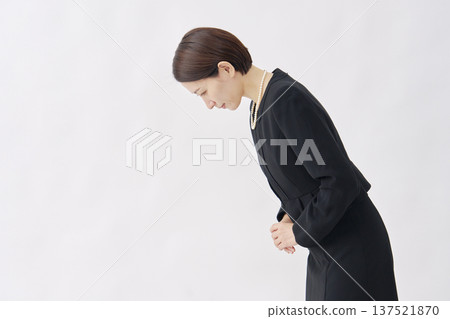 Woman in mourning clothes bowing white background facing left 137521870