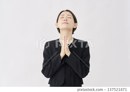 Woman in mourning clothes, hands together in prayer, white background Woman in mourning clothes, hands together in prayer, white background 137521871