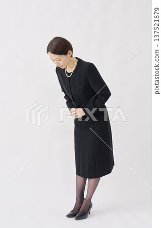 Woman in mourning clothes bowing white background whole body facing left Woman in mourning clothes bowing white background whole body facing left 137521879