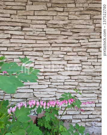 It's a stone wall and a golden bell. 137522780