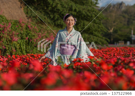 woman in yukata (kimono dress) with flower blooming in garden 137522966