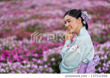 woman in yukata (kimono dress) with flower blooming in garden woman in yukata (kimono dress) with flower blooming in garden 137522986