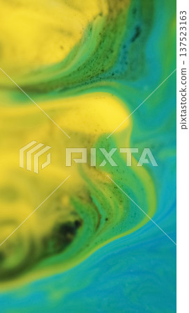 Defocused ink blend. Color dye stream. Blue yellow green pigment water flow bright texture marble liquid spill on abstract background. Defocused ink blend. Color dye stream. Blue yellow green pigment water flow bright texture marble liquid spill on abstract background. 137523163
