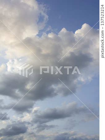 It's a blue sky with atmospheric puffy clouds. 137523214