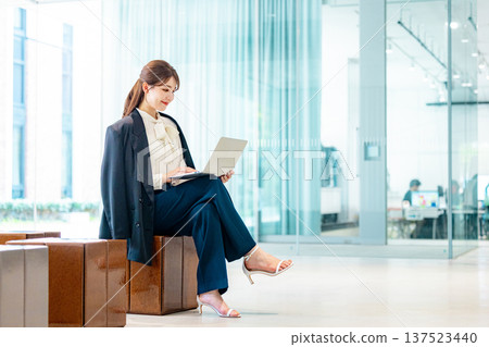Middle-aged business woman operating a personal computer in the office 137523440