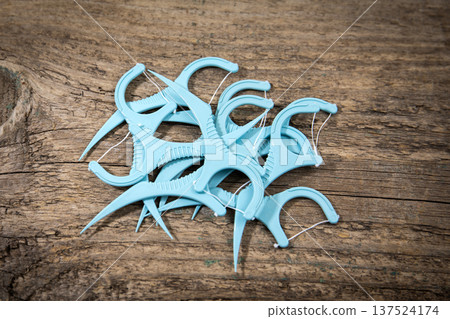 Pile Of Dental Floss Picks On Rustic Wooden Surface Closeup Pile Of Dental Floss Picks On Rustic Wooden Surface Closeup 137524174