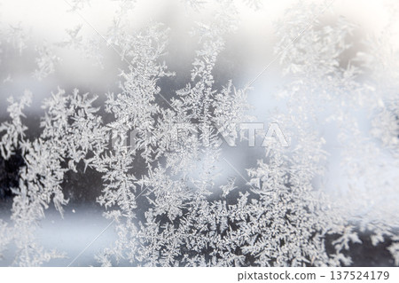 Ice Frost Crystal Patterns On Window Glass During Cold Winter Morning 137524179