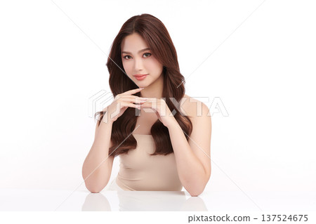 A beautiful young Asian woman with clean, fresh skin against a white background. Skincare, facial treatment, cosmetology, beauty, and spa. An elegant portrait of an Asian woman. A beautiful young Asian woman with clean, fresh skin against a white background. Skincare, facial treatment, cosmetology, beauty, and spa. An elegant portrait of an Asian woman. 137524675