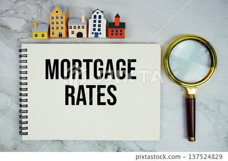 Mortgage Rates text written on notepad with house model and magnifying glass on marble background Mortgage Rates text written on notepad with house model and magnifying glass on marble background 137524829