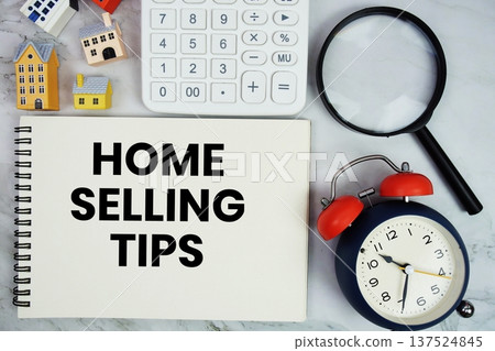 Home Selling Tips text written on notepad with house model, magnifying glass and alarm clock on marble background Home Selling Tips text written on notepad with house model, magnifying glass and alarm clock on marble background 137524845