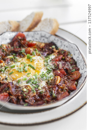 Shakshuka brunch dish on white table at outdoors restaurant in israel Shakshuka brunch dish on white table at outdoors restaurant in israel 137524997