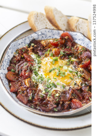Shakshuka brunch dish on white table at outdoors restaurant in israel Shakshuka brunch dish on white table at outdoors restaurant in israel 137524998