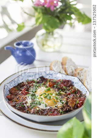 Shakshuka brunch dish on white table at outdoors restaurant in israel Shakshuka brunch dish on white table at outdoors restaurant in israel 137525002