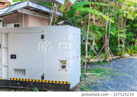Backup power generator installed outside tropical house in residential yard Backup power generator installed outside tropical house in residential yard 137525219