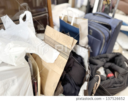 Carry-on cases and scattered paper bags 137526652