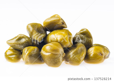 Green capers stacked on a white background in a simple arrangement Green capers stacked on a white background in a simple arrangement 137528214