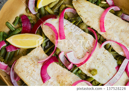 Fresh fish and vegetables cooked together in a skillet with lemon and onions Fresh fish and vegetables cooked together in a skillet with lemon and onions 137528226