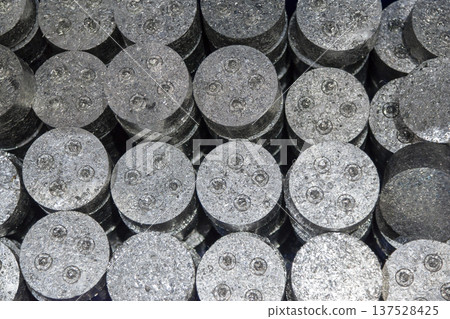 Cylindrical compressed aluminum scrap bales prepared for secondary smelting in a metal recycling facility. Cylindrical compressed aluminum scrap bales prepared for secondary smelting in a metal recycling facility. 137528425