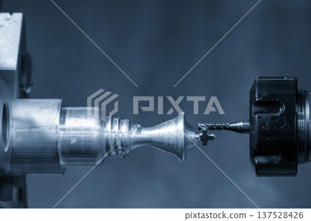 High-precision CNC turn-mill center using a live tooling milling spindle to machine the end face of a metal component. 137528426