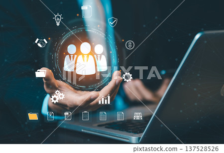 Businessman presenting HR management system on laptop. Concept of human resources, recruitment technology, digital workforce, and personnel management. 137528526
