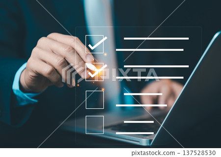 Hand using pen to tick check boxes on digital screen. Concept of checklist, quality control, survey, task management, and project completion. Hand using pen to tick check boxes on digital screen. Concept of checklist, quality control, survey, task management, and project completion. 137528530